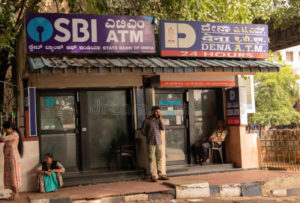 bangalore-india-june-people-sitting-infront-sbi-atm-dena-bank-s-railway-station-149955579