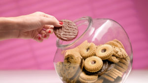 Woman stealing biscuit, caught in the act.