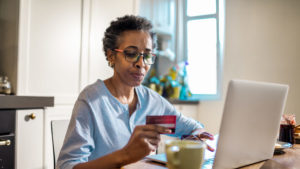 Senior woman online shopping on her laptop