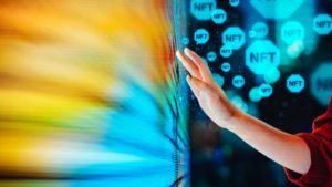 Fake job offer leads to $600 million theft 21 Close up of woman's hand touching colourful and illuminated LED display screen, working with blockchain technologies, investing or trading NFT (Non-Fungible Token) on cryptocurrency, digital asset, art work and digital ledger