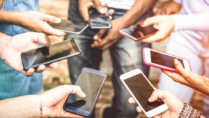 WhatsApp warns users: Fake versions of WhatsApp are trying to steal your personal info 36 Friends group having addicted fun together using smartphones - Hands detail sharing content on social network with mobile smart phone - Technology concept with people millennials online with cellphone