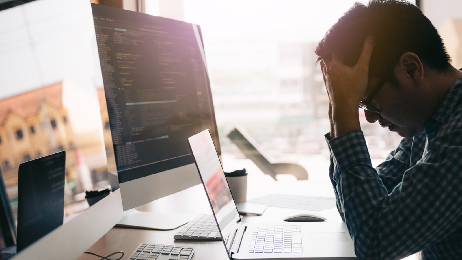 Worker strained at their computer