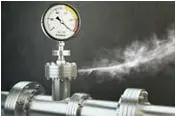 Gas or steam leaking from an industrial pressure gauge