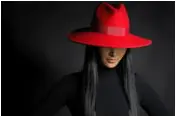 Woman in ret hat photo via Shutterstock